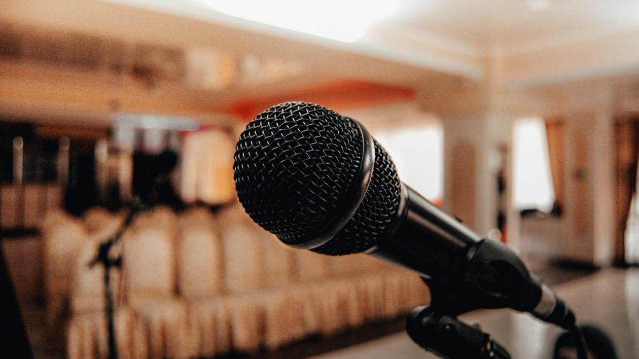 Microphone in an empty conference room, symbol of crisis communication and public brand response